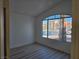 Inviting bedroom with laminate floors and a large arch window offering neighborhood views at 6636 Old Oxford Ave, Las Vegas, NV 89108