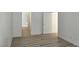 Bedroom with fresh paint and new flooring, leading to the bathroom at 6636 Old Oxford Ave, Las Vegas, NV 89108