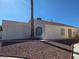 Side view of house featuring neutral stucco and red tile roof, complimented by desert landscaping at 6636 Old Oxford Ave, Las Vegas, NV 89108