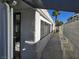 Side view of the house highlighting the windows, stucco exterior, and block wall for added privacy at 6636 Old Oxford Ave, Las Vegas, NV 89108