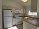 Well-lit kitchen featuring white appliances, ample counter space, and neutral cabinetry at 6636 Old Oxford Ave, Las Vegas, NV 89108