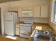 This kitchen features a range, microwave, refrigerator, and updated countertops at 6636 Old Oxford Ave, Las Vegas, NV 89108