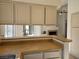 Kitchen with a breakfast bar, laminate countertops, and view to the Gathering room with fireplace at 6636 Old Oxford Ave, Las Vegas, NV 89108
