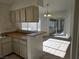 Sunlit kitchen with breakfast bar open to dining area with backyard access through sliding doors at 6636 Old Oxford Ave, Las Vegas, NV 89108