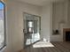 Living room with sliding glass door and fireplace, complemented by wood flooring and natural light at 6636 Old Oxford Ave, Las Vegas, NV 89108