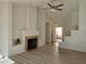 Bright living room with a fireplace, updated flooring, and a modern ceiling fan fixture at 6636 Old Oxford Ave, Las Vegas, NV 89108
