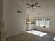 Living room boasting light wood flooring, a ceiling fan, and plenty of natural light from a large window at 6636 Old Oxford Ave, Las Vegas, NV 89108