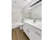 Bathroom features white cabinets, large mirror, and modern fixtures at 6696 Merced Lake Dr, Las Vegas, NV 89156