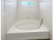 Clean bathtub surrounded by white tile at 6696 Merced Lake Dr, Las Vegas, NV 89156