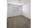 Bright bedroom with window, neutral carpet, and freshly painted white walls at 6696 Merced Lake Dr, Las Vegas, NV 89156