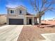 Charming two-story home with a neutral color palette, attached garage, and low-maintenance landscaping at 6696 Merced Lake Dr, Las Vegas, NV 89156
