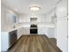 Bright kitchen featuring white cabinets, stainless steel appliances, and wood floors at 6696 Merced Lake Dr, Las Vegas, NV 89156