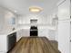 Well-lit kitchen with stainless steel appliances, wood floors, and white cabinets at 6696 Merced Lake Dr, Las Vegas, NV 89156