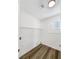 Clean laundry room with wood floor, window, and shelving at 6696 Merced Lake Dr, Las Vegas, NV 89156
