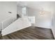 Bright living room with wood floors, staircase, and modern chandelier at 6696 Merced Lake Dr, Las Vegas, NV 89156