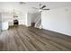 Spacious open-concept featuring wood floors, a stairway to the second floor, and an open floor plan to the kitchen at 6696 Merced Lake Dr, Las Vegas, NV 89156
