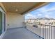 Spacious balcony with metal railing and views of a suburban street at 6850 Magenta Moon St, North Las Vegas, NV 89086