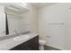 Bathroom with a dark vanity, granite countertop, and a shower with a curtain at 6850 Magenta Moon St, North Las Vegas, NV 89086