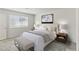 Serene bedroom with soft bedding, elegant bedside tables, and a cozy bench for relaxation at 6850 Magenta Moon St, North Las Vegas, NV 89086