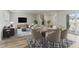 Inviting living room and dining area featuring stylish decor, comfortable seating, and abundant natural light at 6850 Magenta Moon St, North Las Vegas, NV 89086