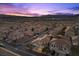 Beautiful sunset view of a residential neighborhood with well-maintained homes and manicured landscaping at 694 Value Ridge Ave, Henderson, NV 89012