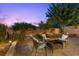A backyard patio with brick pavers, an outdoor seating area, landscaping, and privacy fencing at 694 Value Ridge Ave, Henderson, NV 89012