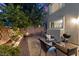 A brick paver patio with an outdoor seating area, barbecue grill, and manicured landscaping at 694 Value Ridge Ave, Henderson, NV 89012