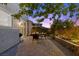 A backyard patio with brick pavers, an outdoor seating area, landscaping, and privacy fencing at 694 Value Ridge Ave, Henderson, NV 89012