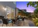 A brick paver patio with an outdoor seating area and barbecue grill, adjacent to the kitchen at 694 Value Ridge Ave, Henderson, NV 89012