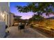 A backyard patio with brick pavers, an outdoor seating area, barbecue grill, and privacy fencing at 694 Value Ridge Ave, Henderson, NV 89012