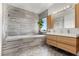 Beautiful bathroom features stylish gray tilework, modern fixtures, and a soaking tub at 694 Value Ridge Ave, Henderson, NV 89012