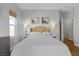 Bedroom has a woven headboard, hardwood floors, neutral walls, and a bright window at 694 Value Ridge Ave, Henderson, NV 89012