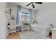 Bedroom has a ceiling fan, a white desk, and mountain views from the bright window at 694 Value Ridge Ave, Henderson, NV 89012