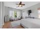 Bedroom with hard wood floors, a ceiling fan, and bright windows providing ample lighting at 694 Value Ridge Ave, Henderson, NV 89012