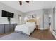 Bedroom has a woven headboard, hardwood floors, and a flat screen television on the wall at 694 Value Ridge Ave, Henderson, NV 89012