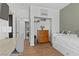 A bedroom with white trim has a pull out bed, wood floors and a wooden dresser at 694 Value Ridge Ave, Henderson, NV 89012