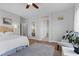 Bedroom with a large bed, ceiling fan, hardwood floors, and entryways to the bathroom at 694 Value Ridge Ave, Henderson, NV 89012