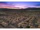 A sunset aerial view showing rows of desert homes with beautiful mountain backdrops at 694 Value Ridge Ave, Henderson, NV 89012