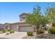 Charming two-story home with a two-car garage, a Juliet balcony and a manicured front yard at 694 Value Ridge Ave, Henderson, NV 89012