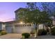 Beautiful home with a two-car garage, charming balcony, and lush landscaping with mature shade trees at 694 Value Ridge Ave, Henderson, NV 89012