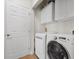 Efficient laundry room features modern appliances and built-in cabinets for organized storage at 694 Value Ridge Ave, Henderson, NV 89012