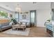 Comfortable living room featuring hardwood floors, stylish sofas, and art at 694 Value Ridge Ave, Henderson, NV 89012
