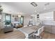 Open-concept living room and dining area with hardwood floors and elegant lighting at 694 Value Ridge Ave, Henderson, NV 89012