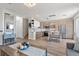 Open-concept home with a living room that flows into a modern kitchen at 694 Value Ridge Ave, Henderson, NV 89012
