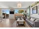 Bright living room with sliding glass doors, stylish sofas, and backyard views at 694 Value Ridge Ave, Henderson, NV 89012