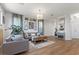 Inviting living room features hardwood floors, stylish decor, and a modern chandelier at 694 Value Ridge Ave, Henderson, NV 89012
