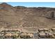 The rear of the home features lush desert landscaping and dramatic mountain views at 694 Value Ridge Ave, Henderson, NV 89012