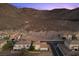 View of the rear of the home with desert landscaping and beautiful mountain views at 694 Value Ridge Ave, Henderson, NV 89012