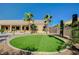 Well-manicured backyard with artificial grass area, desert landscaping, and a pool at 6971 Moaning Cavern St, Las Vegas, NV 89131