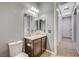 Bathroom with a vanity, toilet, tile flooring, and access to the hallway at 6971 Moaning Cavern St, Las Vegas, NV 89131